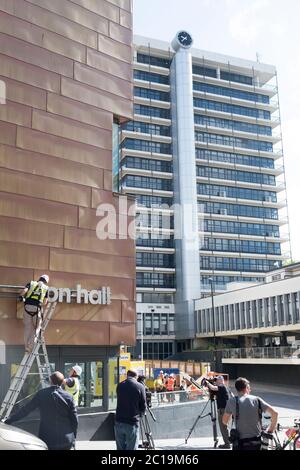 Bristol, UK. 15th June, 2019. The sign for the Colston Hall is removed today. Edward Colston has been a contentious figure in Bristol's history, in 2018 the board of the Colston Hall decided Colston was a toxic brand and decided to change the name of this prestigious venue. The Black Lives Matter protest where the statue of Colston was thrown in the harbour has energised the removal of his name from the hall. Colston Tower where the name was removed last week in the background. Credit: Mr Standfast/Alamy Live News Stock Photo