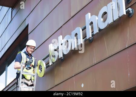 Bristol, UK. 15th June, 2019. The sign for the Colston Hall is removed today. Edward Colston has been a contentious figure in Bristol's history, in 2018 the board of the Colston Hall decided Colston was a toxic brand and decided to change the name of this prestigious venue. The Black Lives Matter protest where the statue of Colston was thrown in the harbour has energised the removal of his name from the hall. Credit: Mr Standfast/Alamy Live News Stock Photo