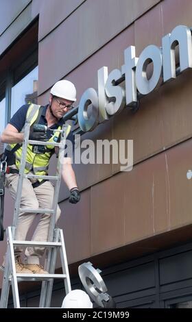 Bristol, UK. 15th June, 2019. The sign for the Colston Hall is removed today. Edward Colston has been a contentious figure in Bristol's history, in 2018 the board of the Colston Hall decided Colston was a toxic brand and decided to change the name of this prestigious venue. The Black Lives Matter protest where the statue of Colston was thrown in the harbour has energised the removal of his name from the hall. Credit: Mr Standfast/Alamy Live News Stock Photo