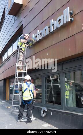 Bristol, UK. 15th June, 2019. The sign for the Colston Hall is removed today. Edward Colston has been a contentious figure in Bristol's history, in 2018 the board of the Colston Hall decided Colston was a toxic brand and decided to change the name of this prestigious venue. The Black Lives Matter protest where the statue of Colston was thrown in the harbour has energised the removal of his name from the hall. Credit: Mr Standfast/Alamy Live News Stock Photo