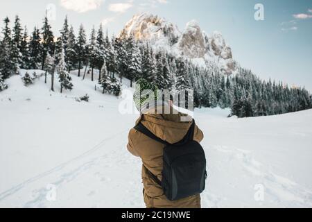Professional photographer taking photos from a snow covered trees and mountains Stock Photo
