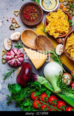 Cooking pasta ingredients background. Raw ingredients for the preparation of Italian pasta, top view. Stock Photo