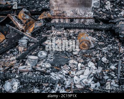 burned down house, remnants of burned down, destroyed house, dishes, garbage after a fire Stock Photo