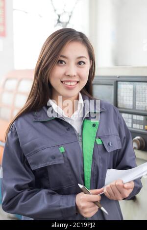 young asian woman works in workshop Stock Photo