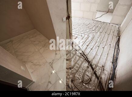 Snapshot of floor before and after renovation. Warm floor in every part of apartment, floor heating pipe system before and after tile layer. Concept of apartment renovation and restoration. Stock Photo