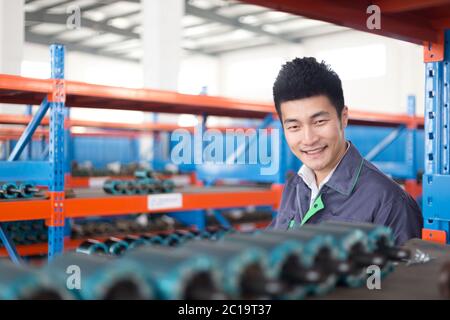 young asian man works in workshop Stock Photo
