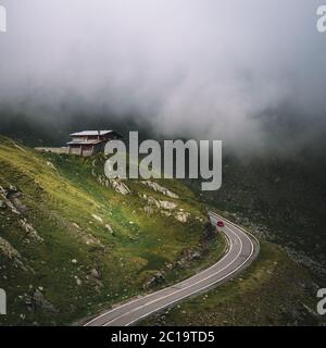 Car Traveling On Mountain In Clouds,Transfagarasan,Romania Stock Photo