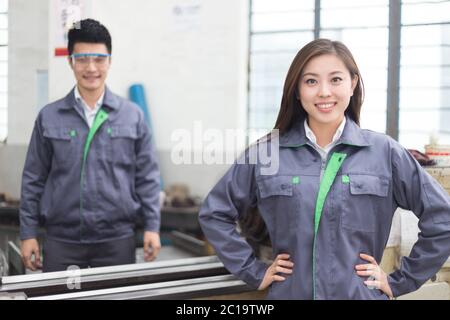 young asian man and woman work in workshop Stock Photo