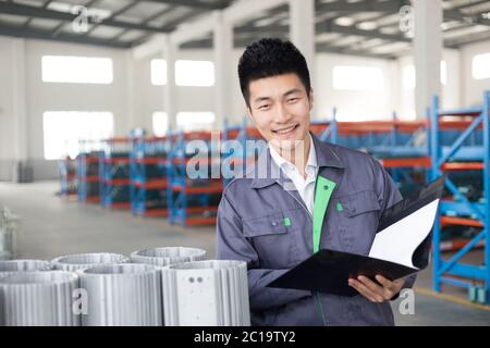 young asian man works in workshop Stock Photo
