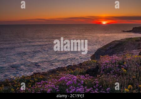 Sunset over the water at Bedruthan Steps Cornwall Stock Photo
