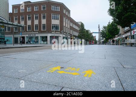 Exeter, Devon, UK.  15th June 2020.   Shops selling unessential items allowed to reopen today as coronavirus lockdown is eased further. Freshly painted social distancing marks painted on the pavement at Exeter in Devon.  Picture Credit: Graham Hunt/Alamy Live News Stock Photo