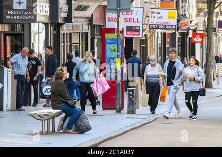 Exeter, Devon, UK.  15th June 2020.   Shops selling unessential items allowed to reopen today as coronavirus lockdown is eased further. Shoppers on the High Street at Exeter in Devon.  Picture Credit: Graham Hunt/Alamy Live News Stock Photo