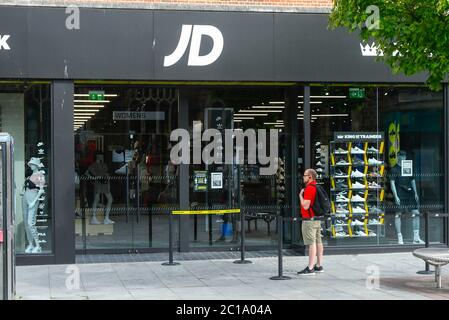 Exeter, Devon, UK.  15th June 2020.   Shops selling unessential items allowed to reopen today as coronavirus lockdown is eased further. The JD Sport shop in the High Street at Exeter with social distancing posters in the window.  Picture Credit: Graham Hunt/Alamy Live News Stock Photo