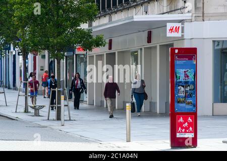 Exeter, Devon, UK.  15th June 2020.   Shops selling unessential items allowed to reopen today as coronavirus lockdown is eased further.  Shoppers walking along the High Street at Exeter.  Picture Credit: Graham Hunt/Alamy Live News Stock Photo