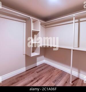 Square crop Walk in closet with double hinged doors plain white wall ...