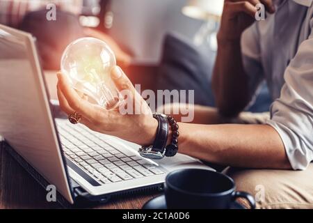 Light blub on businessman hands. Idea, strategy and success concept. Stock Photo