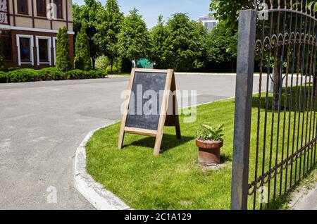 Restaurant sidewalk chalkboard sign board. Chalkboard menu sign mockup. Cafe sign with space for text Stock Photo