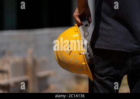 Engineer or construction worker yellow helmet for workers security on the background of construction site Stock Photo