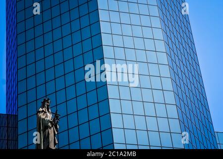 Statue of holy Mary in front of modern glass office building in Santiago Stock Photo