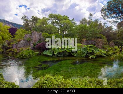 Garden of Ninfa (Latina, Italy) - A private natural monument with medieval ruins in stone, flowers park and an awesome torrent with little fall. Stock Photo