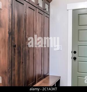 Square Home interior with fire door adjacent to the tall vintage wooden cabinet Stock Photo