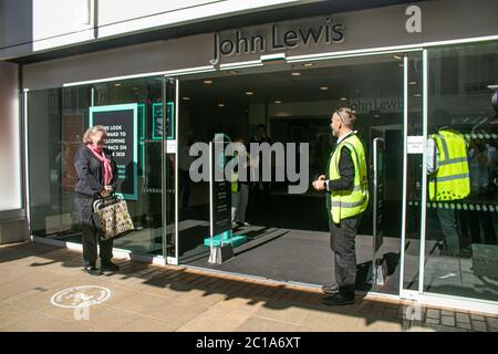 KINGSTON, SURREY, UK. 15 June 2020.  Shoppers queue outside John Lewis department store in kingston on the day non essential shops reopen as part of the government easing  of lockdown measures to revitalize the struggling economy following a 20.4% drop in gross domestic product (GDP) in April and the UK economy heading for one of the worst recession. Credit: amer ghazzal/Alamy Live News Stock Photo