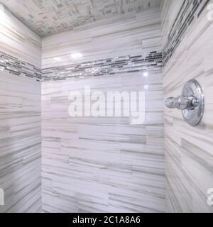Square Shower room of a bathroom with glossy black and gray tiles on wall and ceiling Stock Photo