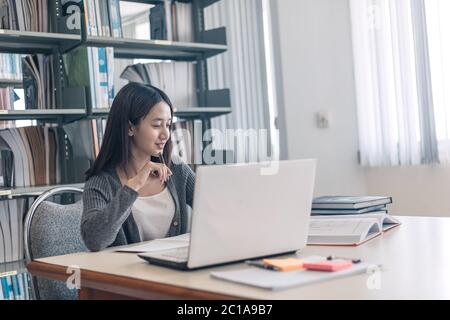High school or college students studying and reading text on laptop. Stock Photo