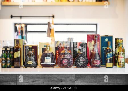 BANGKOK, THAILAND - May 2, 2020 : Many Bottles of old vintage several global whiskey brands on the kitchen table, include liqueur alcohol and whiskey. Stock Photo