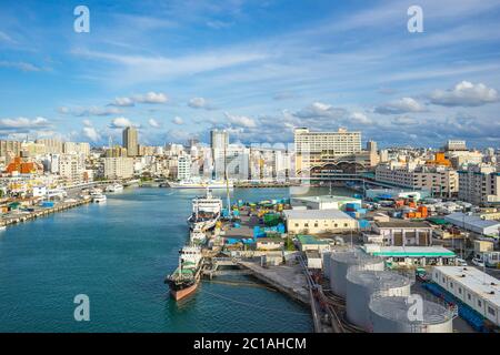 Tomari Port with Okinawa city skyline in Naha, Okinawa, Japan Stock Photo