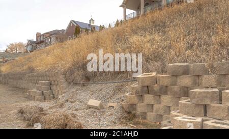 Panorama Stone blocks of collapsed retaining wall holding the soil of a ...