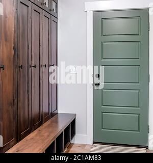 Square frame Hinged panelled wooden fire door with black knob and lock inside a home Stock Photo