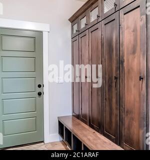 Square crop Home interior with fire door adjacent to the tall vintage wooden cabinet Stock Photo