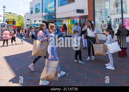 Bournemouth, Dorset UK. 15th June 2020. With the easing of Coronavirus Covid-19 lockdown restrictions, many non-essential shops reopen from today. Primark limit the number of customers allowed in at any one time and has hand sanitiser available amongst other measures including social distancing to protect employees and customers. Mid-day  and long queues as customers eagerly await to get in to do their shopping in Commercial Road, Bournemouth. Credit: Carolyn Jenkins/Alamy Live News Stock Photo