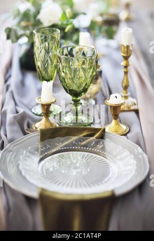 Festive table decorated with candles and covered with a tablecloth Stock Photo