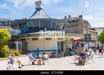 Bournemouth, Dorset UK. 15th June 2020. With the easing of Coronavirus Covid-19 lockdown restrictions, many non-essential shops reopen from today. Visitors stop for something to eat or drink at Obscura Cafe in the Square, as others pass by.  Credit: Carolyn Jenkins/Alamy Live News Stock Photo