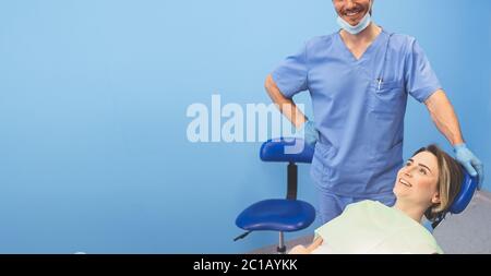 Dentist examining a patient's teeth using dental equipment in dentistry office. Stomatology and health concept. Young handsome male doctor in Stock Photo