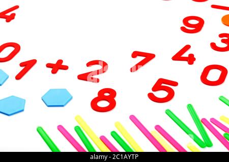 Multicolored plastic figures and numbers on a white background. Educational games for children. Math and calculation skills. Stock Photo