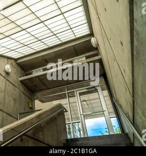 Square crop Indoor staircase of commercial building that leads to the balcony glass door Stock Photo