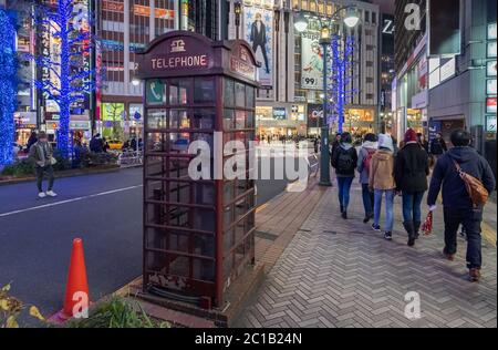 Old telephone booth on the sidewalk street of Shibuya, Tokyo, Japan at night. Stock Photo