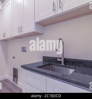 Square frame White fitted kitchen interior with no appliances Stock Photo