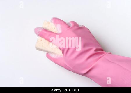 Hand in pink rubber glove is cleaning surface with sponge. Housekeeping and clean service concept. Stock Photo