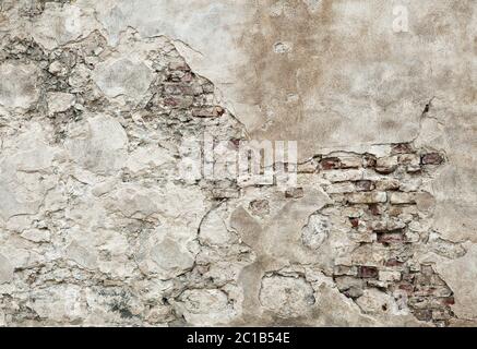 Old wall with brickwork under plaster Stock Photo