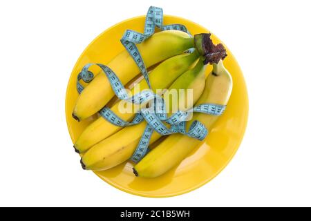 Banana fruits and measuring tape on the plate Stock Photo