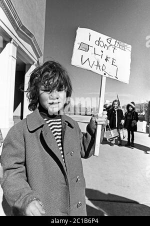 Portrait of a young man holding a sign protesting the Vietnam War, circa 1973, Santa Fe, New Mexico, grounds of the state capitol building. Stock Photo