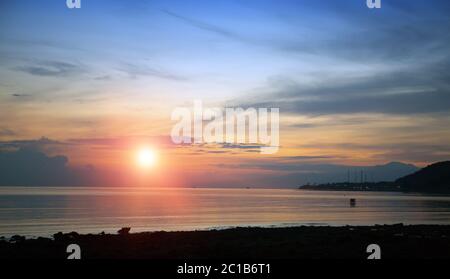 Stony seacoast on a sunset. Indonesia. Bali. Stock Photo