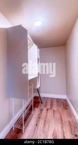 Vertical crop Walk in closet with metal racks and hanging rods mounted ...