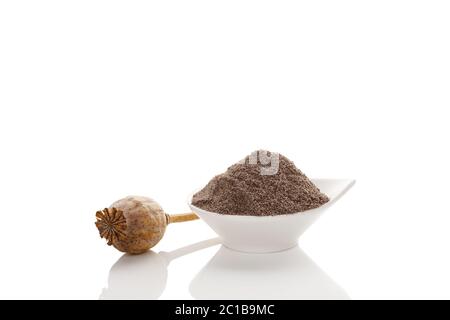 Poppy seeds and dry poppy pod. Stock Photo