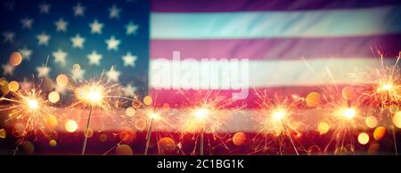 Usa Celebration With Sparklers And Blurred American Flag On Vintage Background Stock Photo