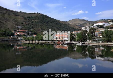 Portugal, Douro Region, Pinhao. Panoramic view of Pinhao and the surrounding hills and vineyards reflected on the Douro River. UNESCO World Heritage. Stock Photo